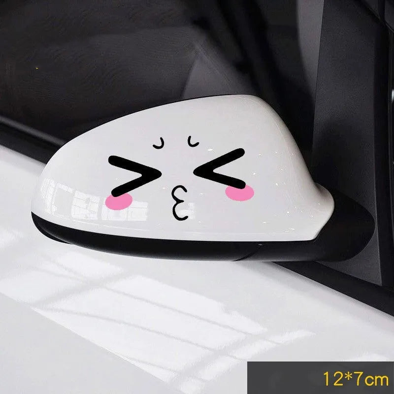 A pair of reflective cartoon car eye stickers on a vehicle body.