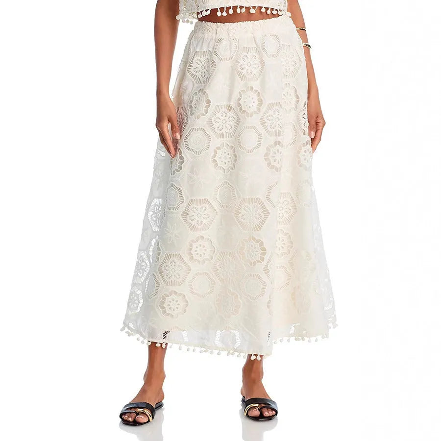 White women's retro style suit set with sleeveless top and embroidered long skirt on hanger