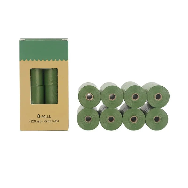 Roll of green EPI degradable pet garbage bags next to a boxed set with a dispenser.