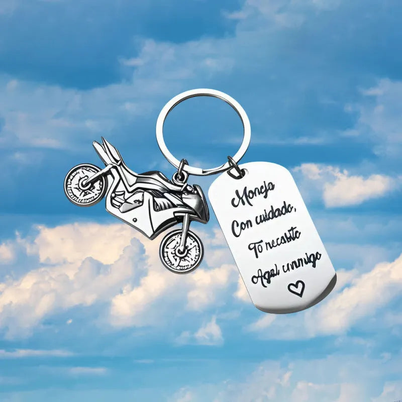 Stainless steel motorcycle key ring with modern design presented with a velvet pouch.