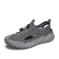Men's black waterproof wading shoes with leather mesh upper, holes for drainage, and a rubber sole.