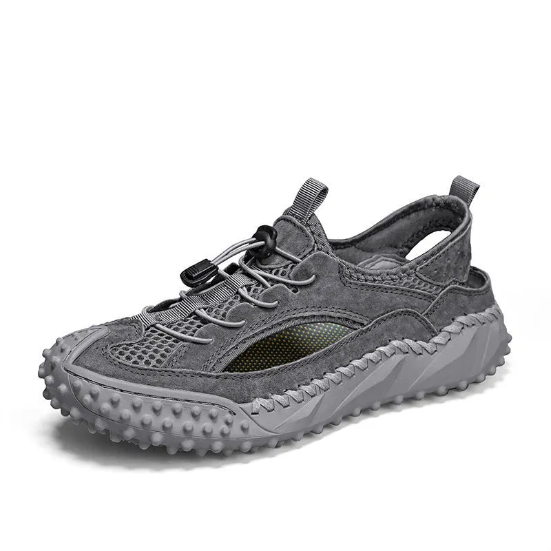 Men's black waterproof wading shoes with leather mesh upper, holes for drainage, and a rubber sole.