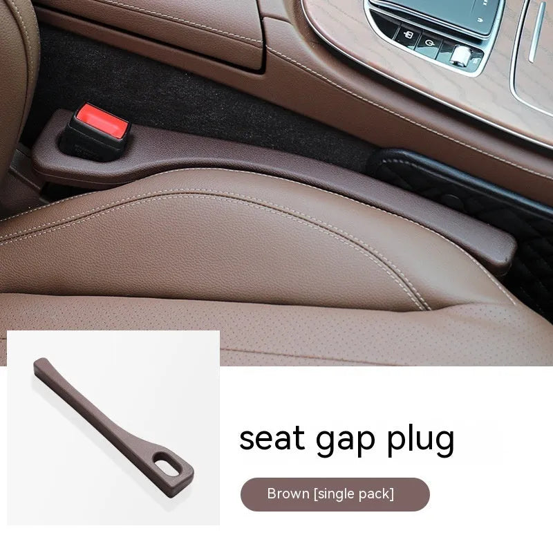 Black polyurethane car seat gap filler strip preventing items falling between vehicle seats