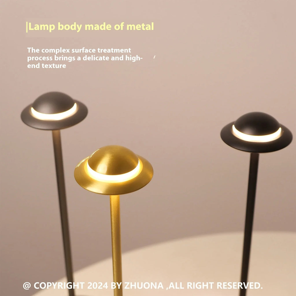 UFO-shaped table lamp with metal base and touch dimming controls in black, gold, or grey colour