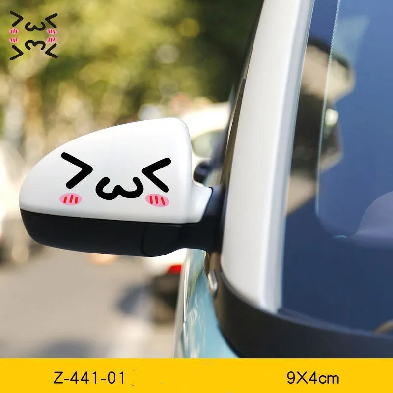 A pair of reflective cartoon car eye stickers on a vehicle body.