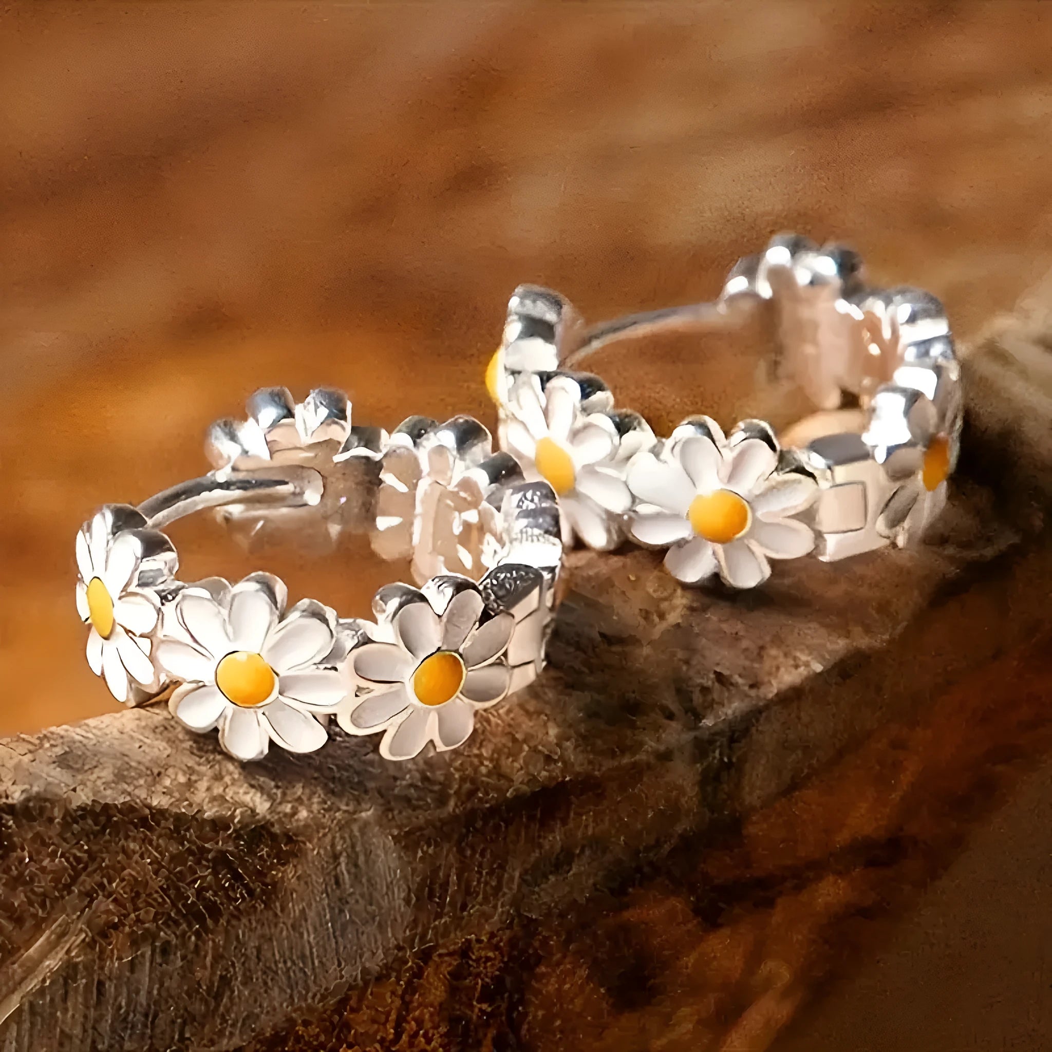 A pair of white daisy flower ring earrings with a platinum-inlaid gemstone detail.