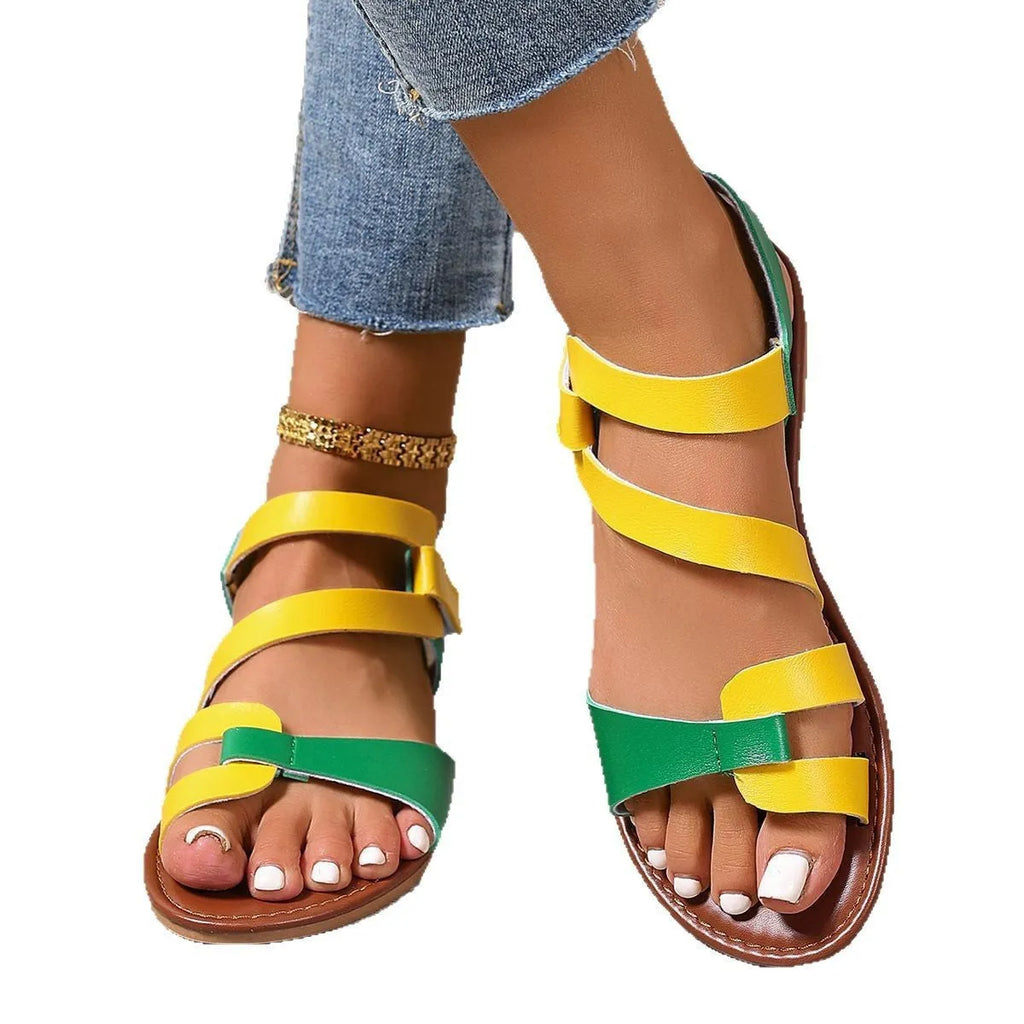 Women's flat sandals with Velcro fastening in black colour showing round toe and rubber sole