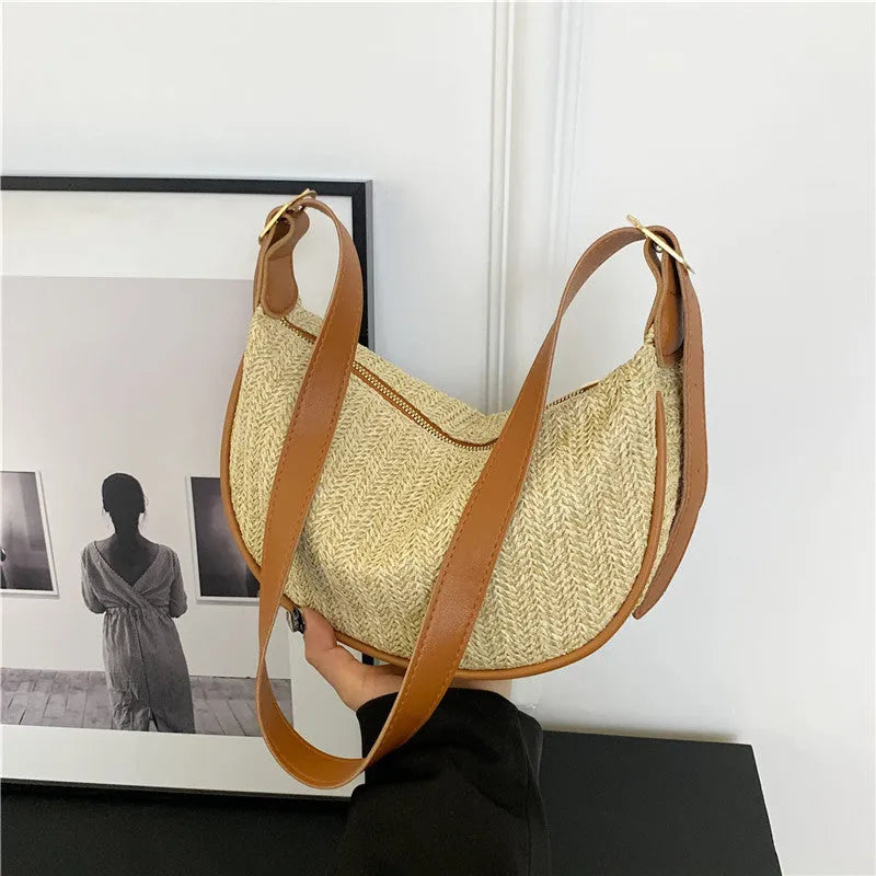 Women's woven straw crossbody bag showing internal phone and document compartments