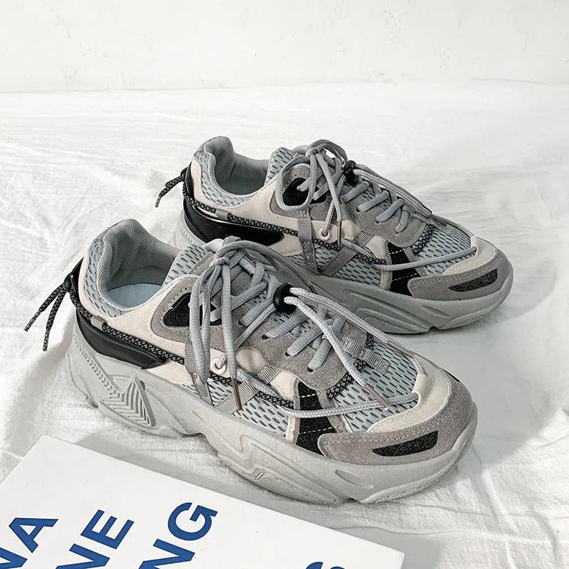 Men's white Korean-style platform dad shoes with a lace-up front on a grey background.