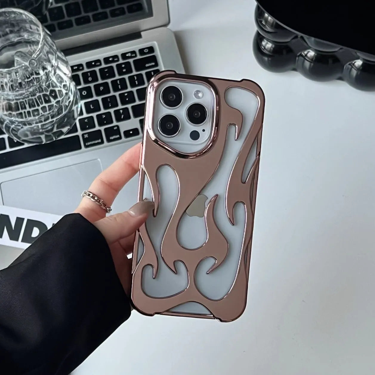 Electroplated iPhone case with hollow flame pattern design in gold, black, purple, and silver finishes