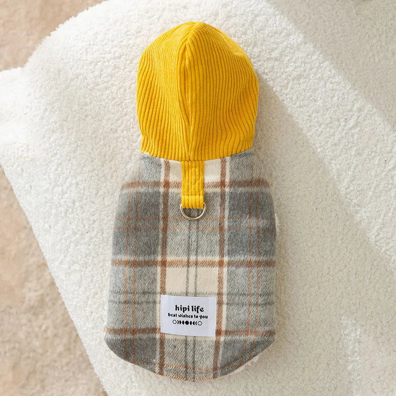 Blue corduroy dog vest with a chessboard grid pattern and an attached yellow hood.