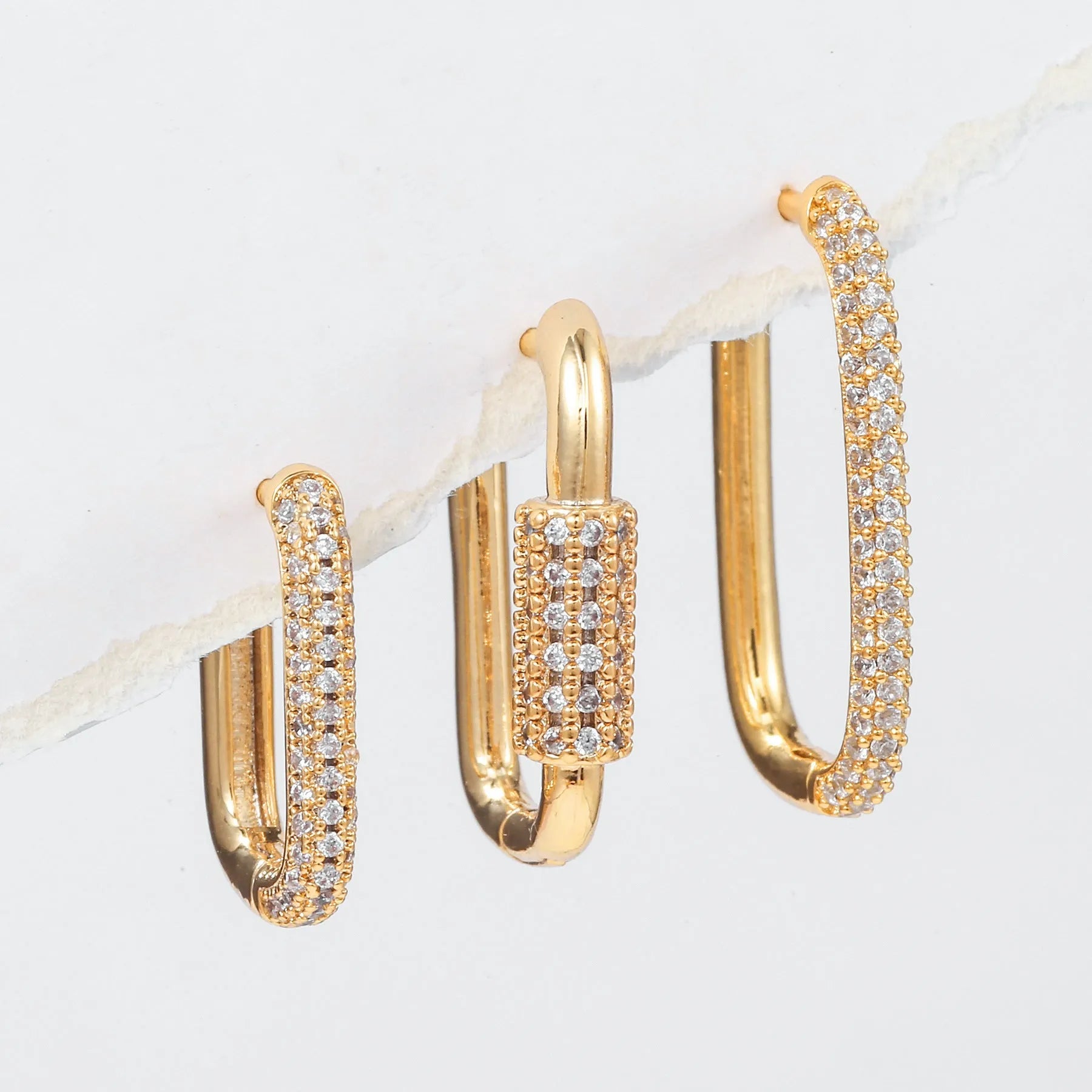 Three geometric ear clips with micro inlaid zircon in gold and white metal colours