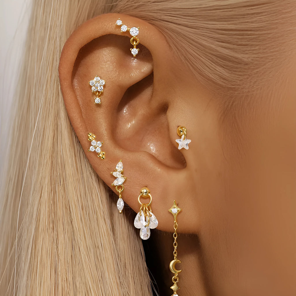 Geometric moon and star sterling silver earrings with diamond accents on a gold-plated finish.