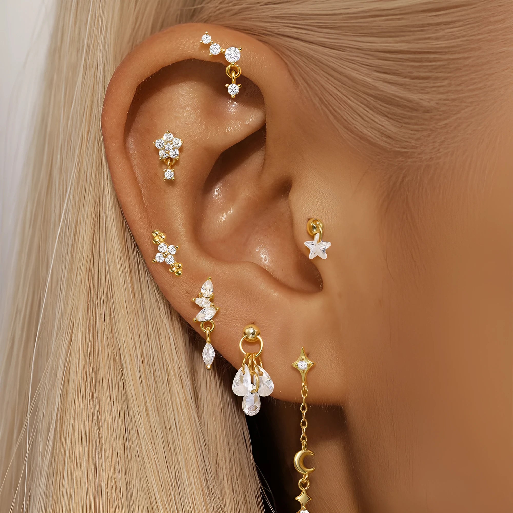 Geometric moon and star sterling silver earrings with diamond accents on a gold-plated finish.