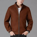 Man wearing a grey fleece sports jacket with a stick pocket on the chest.