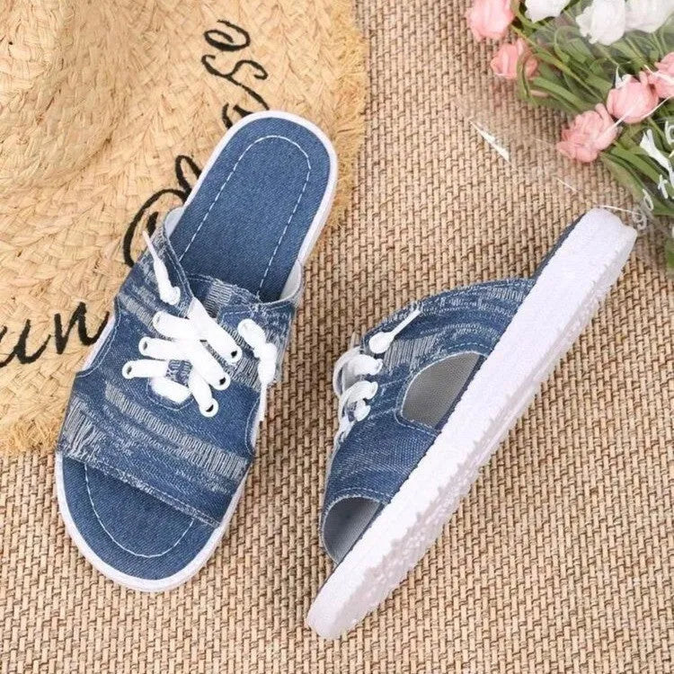Blue Roman style canvas slippers with cloth upper and rubber sole displayed in adult sizes