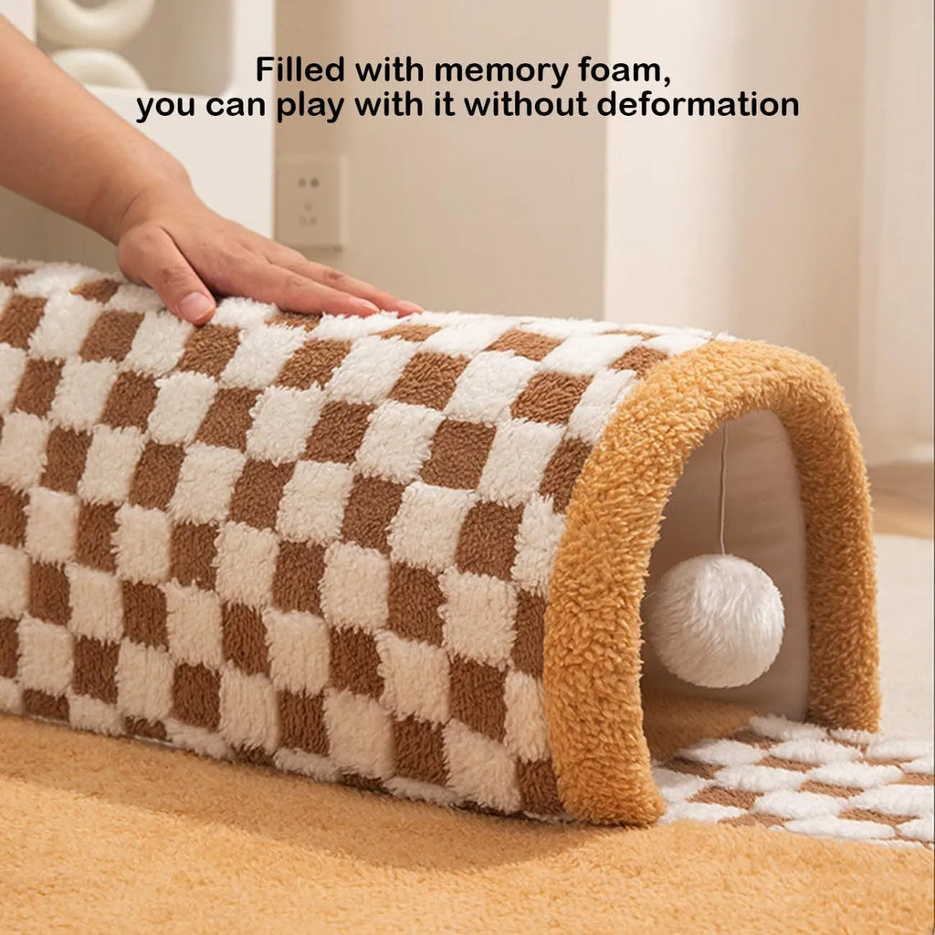 Fan-shaped plaid pet bed with integrated tunnel for dogs and cats in coffee colour, showing soft plush fabric.