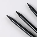 Graphite and carbonized wooden drawing pencils with solid lead cores on suction card packaging