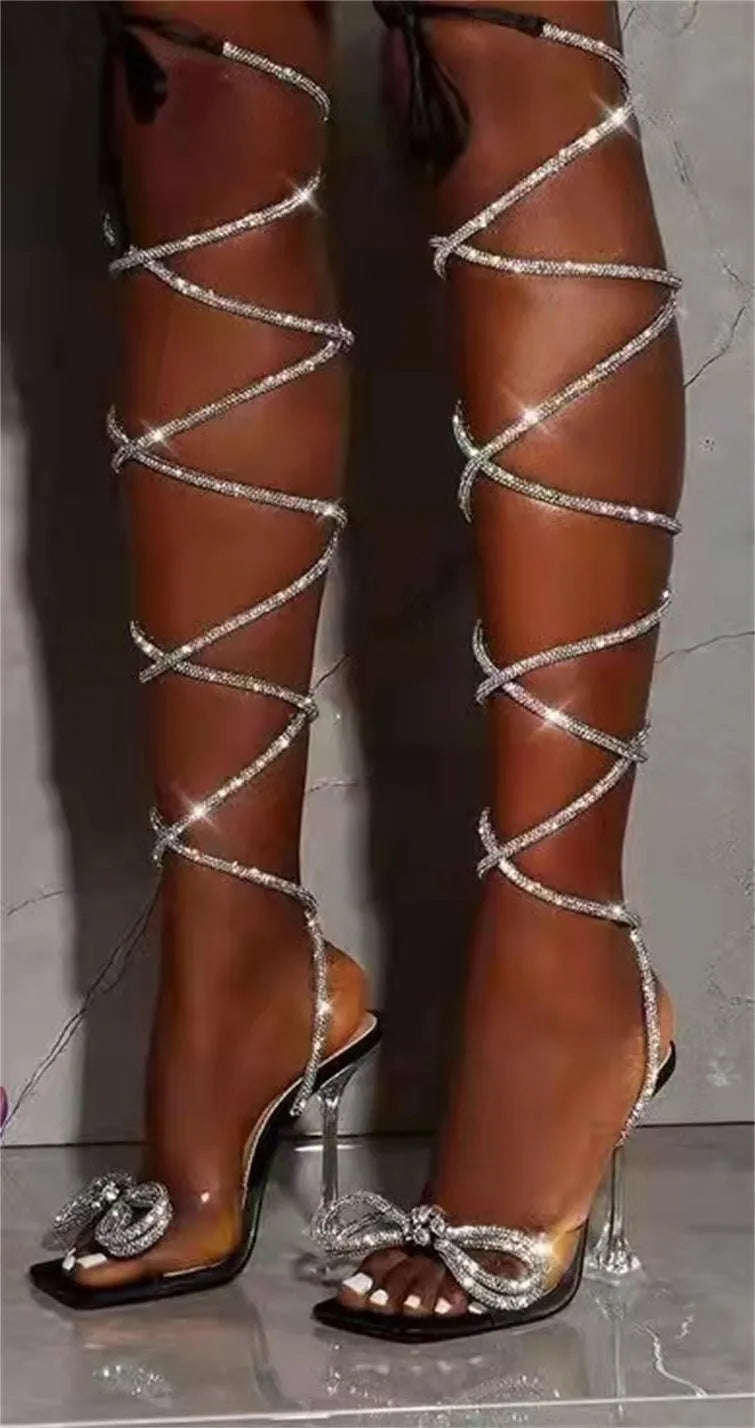 Plus size black strappy high-heeled sandals with rhinestone decoration on a square toe.