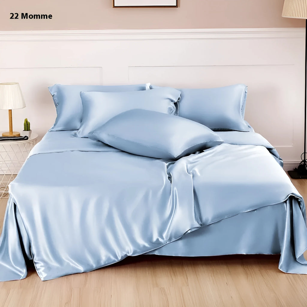 Double-sided solid colour silk duvet cover shown in Lotus Pink on a bed