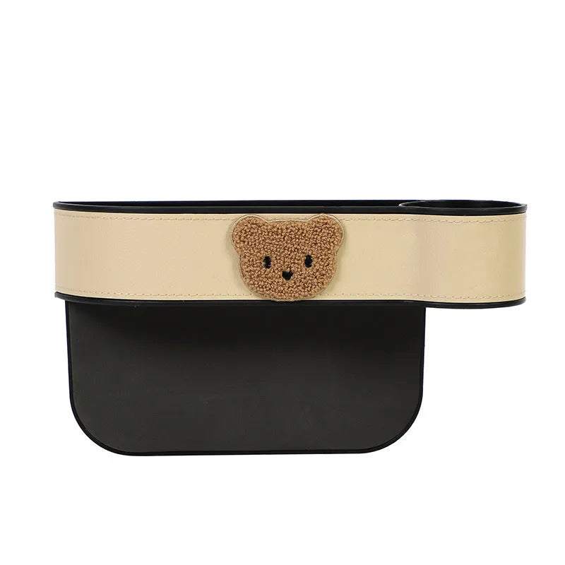 Leather car seat gap storage box with cartoon bear design for organising phones and keys.