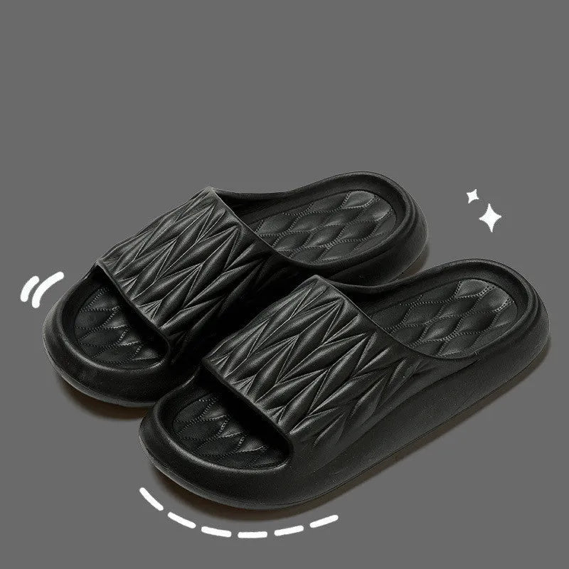 Pair of grey EVA foam slippers with leaf texture pattern and non-slip sole.