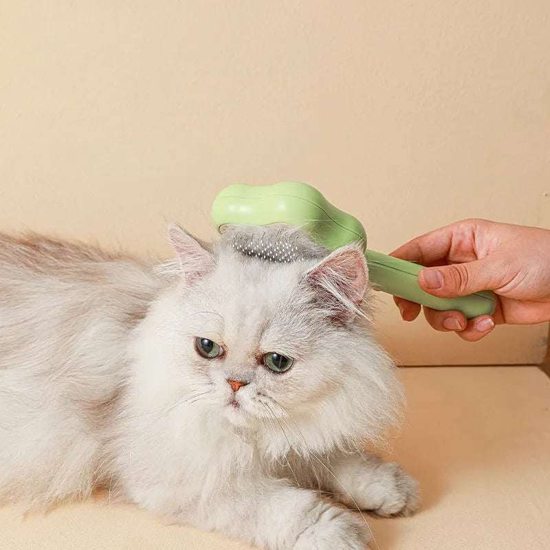 Green pet grooming comb with stainless steel needles and self-cleaning mechanism