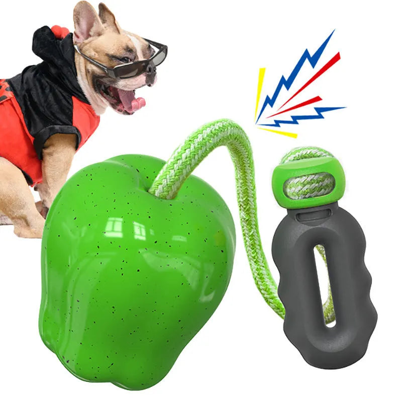 Green and red plastic apple-shaped dog toy with hollow centre for food dispensing