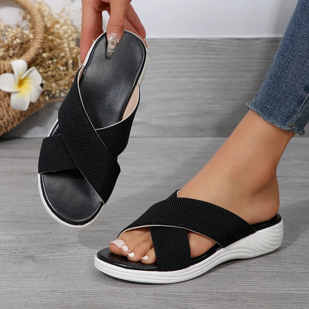 Women's black peep-toe wedge slippers with a thick flat rubber sole