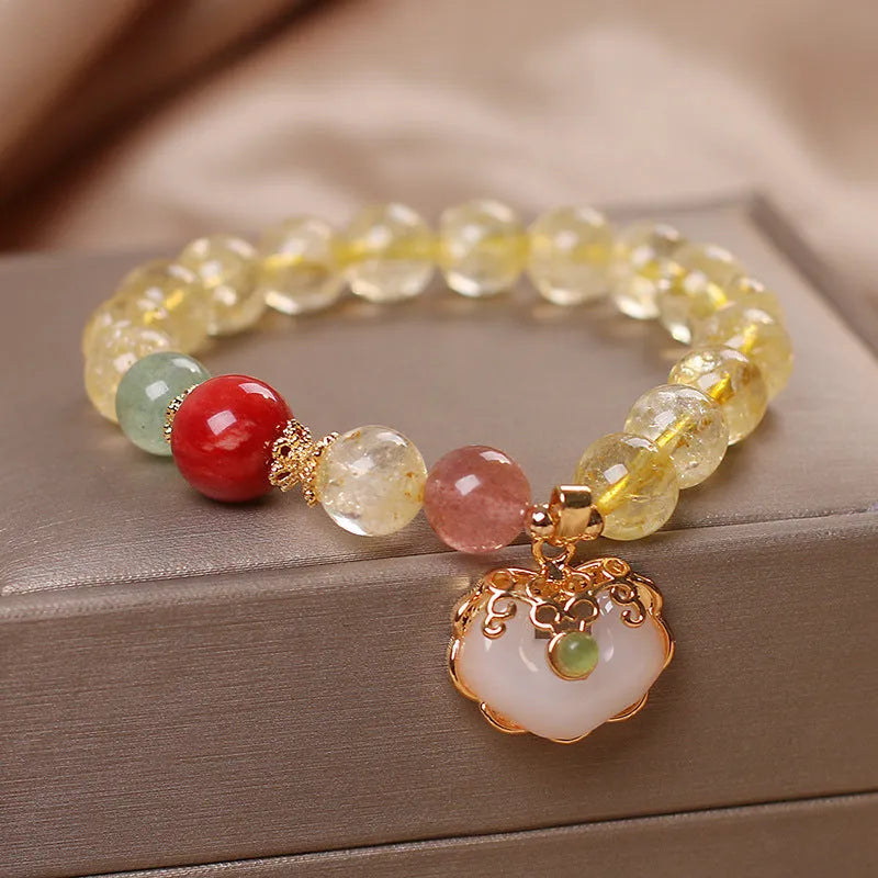 Women's alloy bracelet with a yellow citrine jade ruyi pendant on a white background.