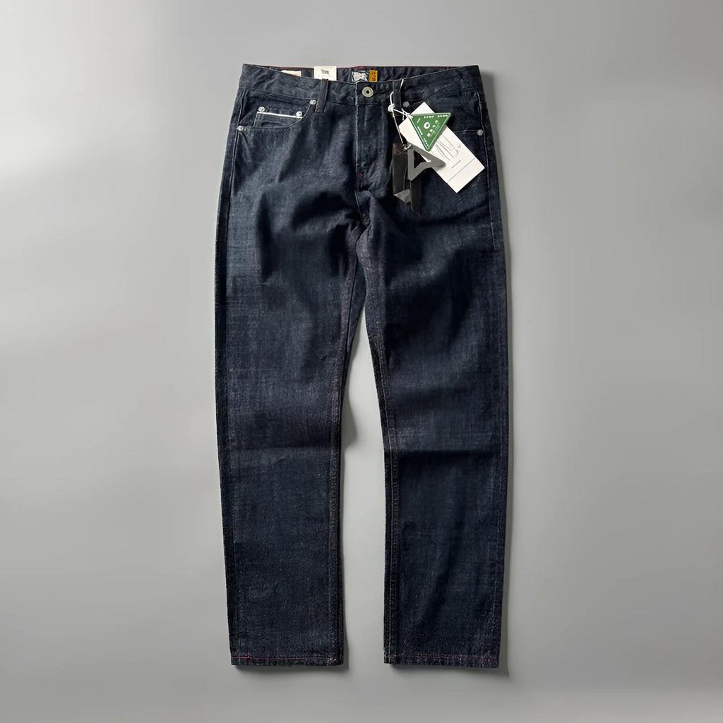 Men's straight leg denim trousers in a primary colour, showing the mid waist fit and long leg.