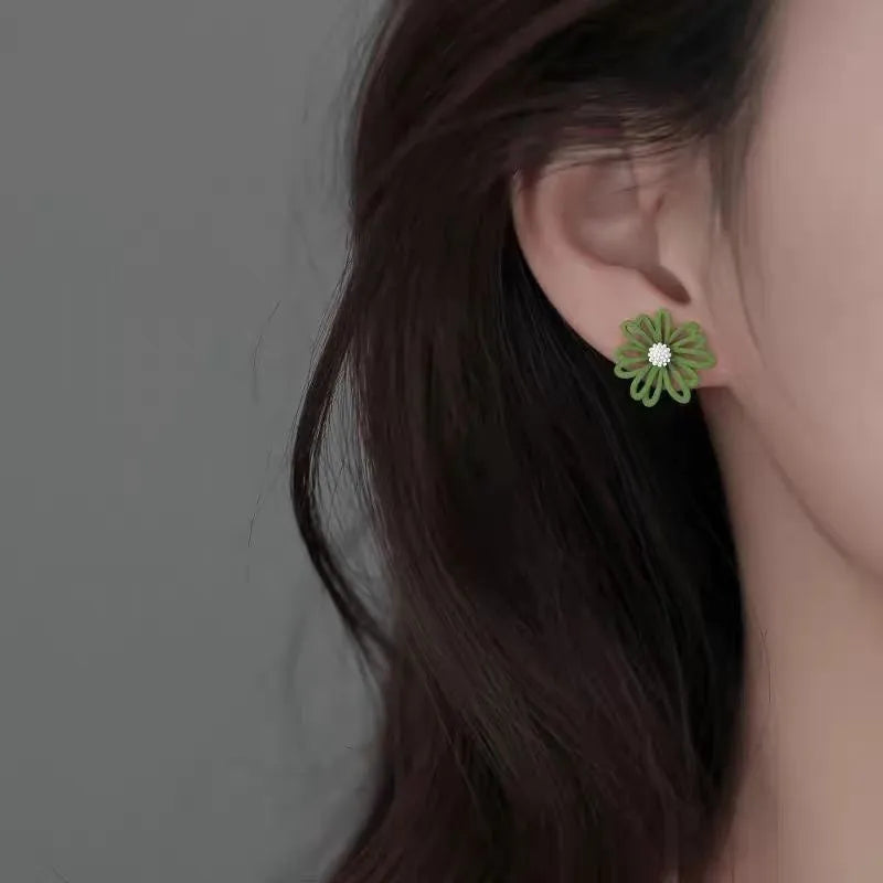Alloy cartoon flower stud earrings in blue and orange, white and green, or yellow and white two-tone colours.