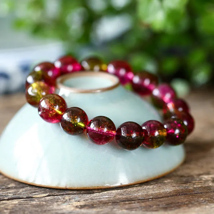 Handmade watermelon-coloured crystal bracelet for women shown in casual style.