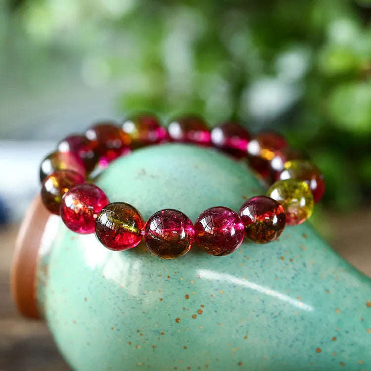 Handmade watermelon-coloured crystal bracelet for women shown in casual style.