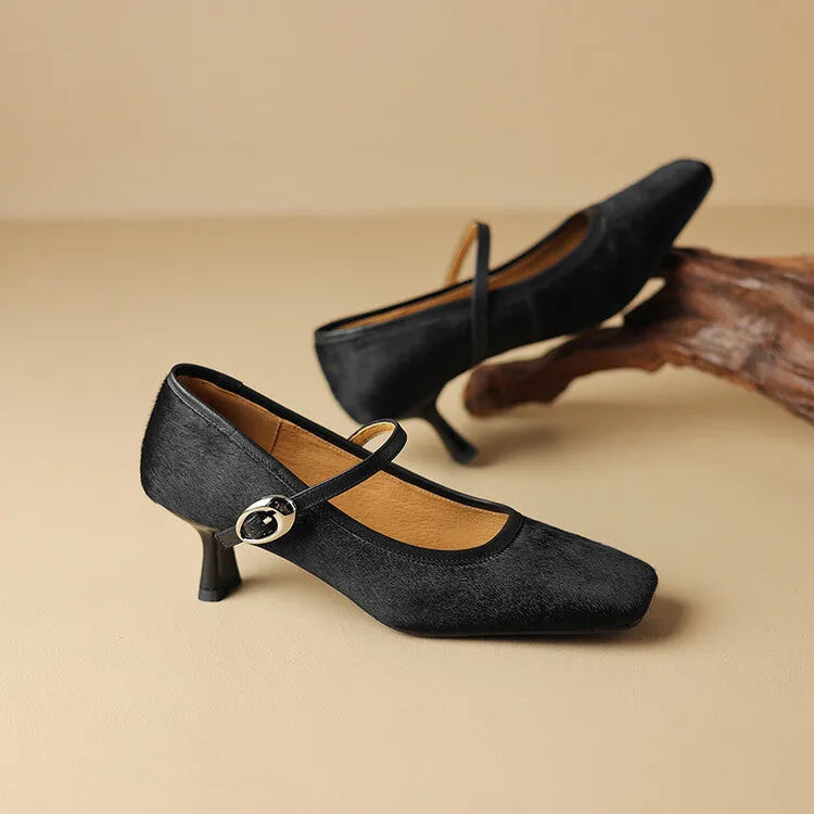 Women's black square toe stiletto ankle-strap shoes with horse hair upper and buckle closure.