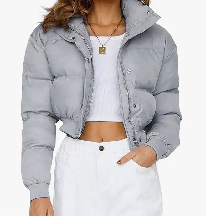 Women's loose blue polyester jacket with long sleeves on a hanger.