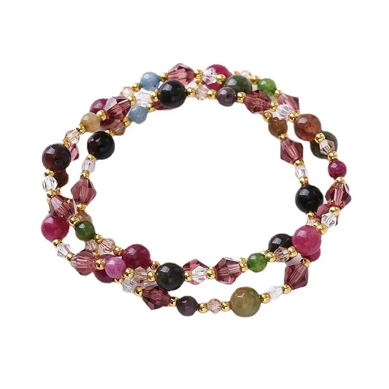 Close-up of a women's adjustable three-ring crystal bracelet in a choice of colours on a wrist.