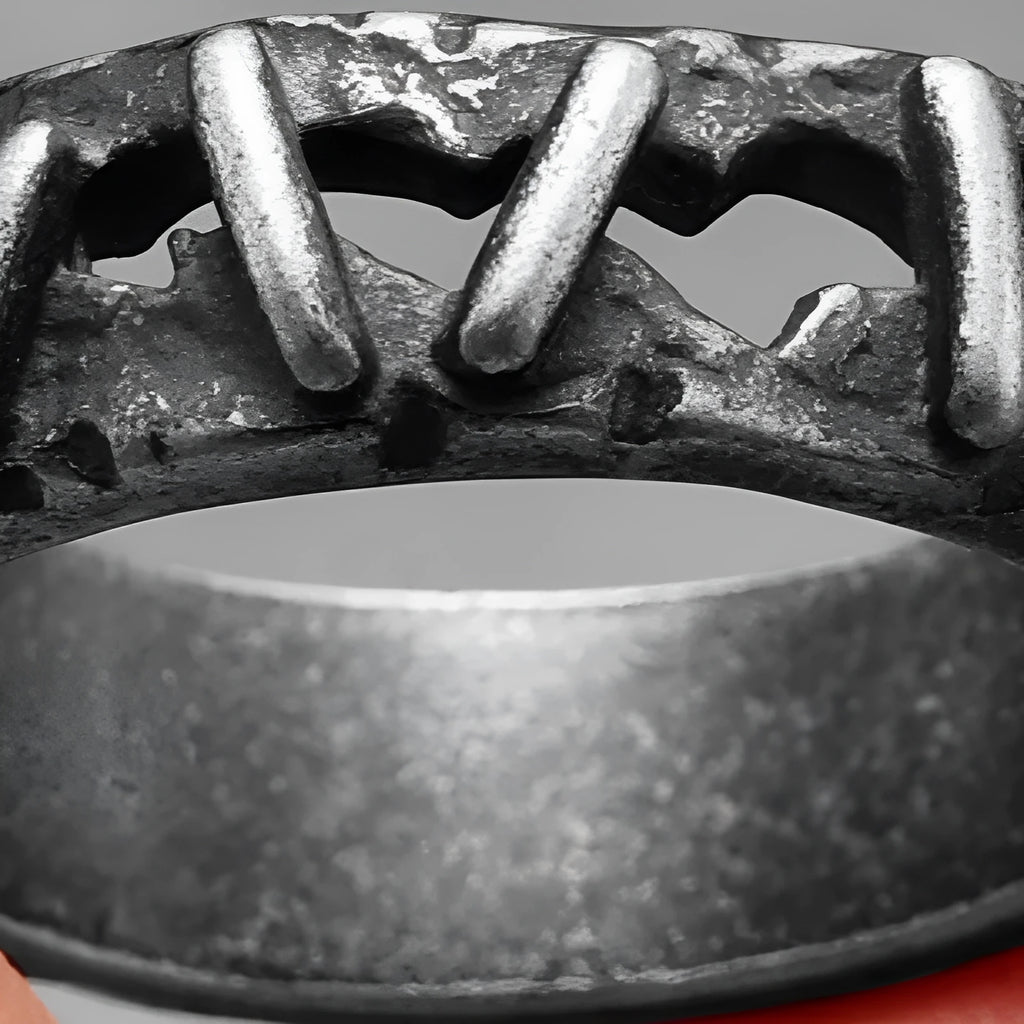 Stainless steel double finger ring with punk-style stitching details, shown in a dark colour.