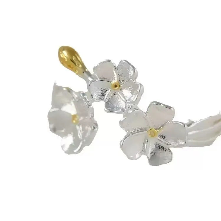 Three-dimensional jasmine flower ring with adjustable open mouth design in zinc alloy.