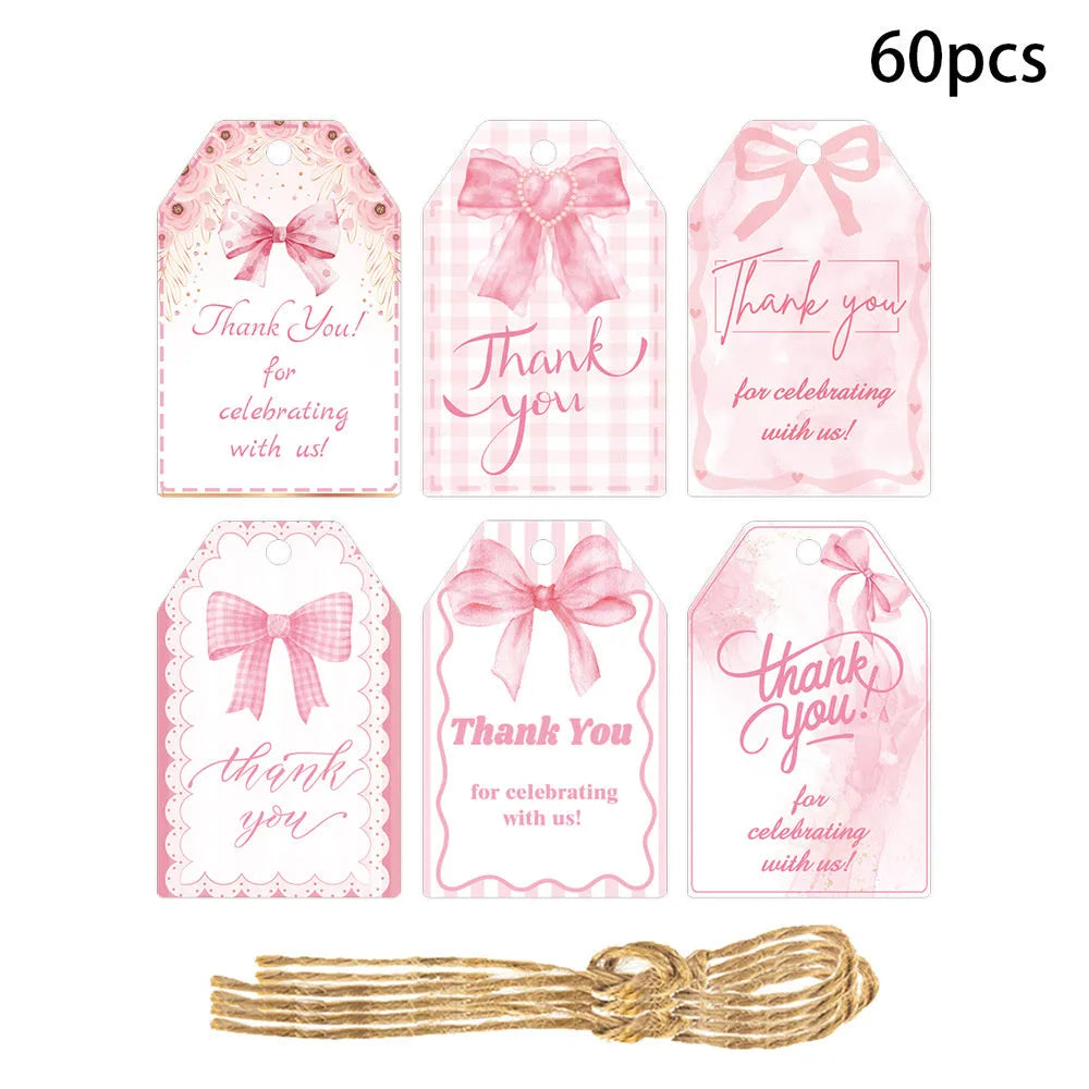 Set of 60 paper birthday gift tags with bowknot designs and natural hemp rope.