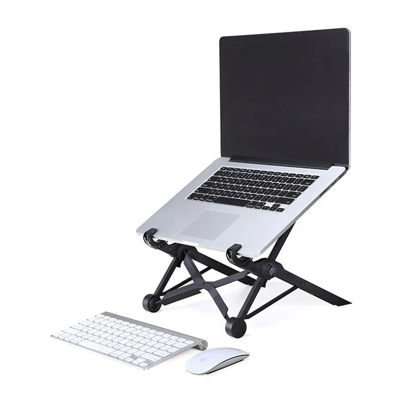 Sagacious black portable folding laptop stand on a wooden desk next to a laptop.