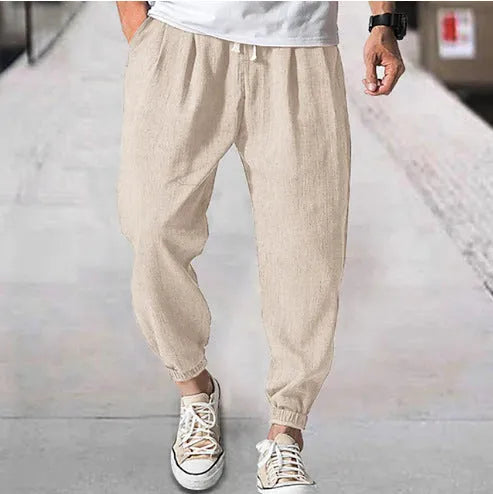 Men's casual cotton trousers with ankle bands in light green colour showing loose fit design