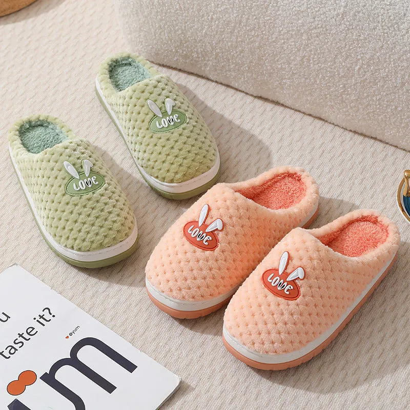 Women's rabbit plaid design artificial fur house slippers with a thick rubber sole.