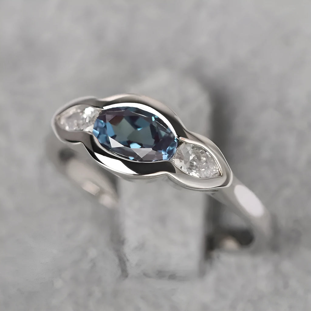 Geometric ellipse ring with inlaid zircon stones in white gold colour on female hand