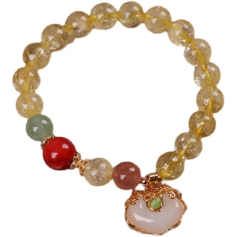 Women's alloy bracelet with a yellow citrine jade ruyi pendant on a white background.