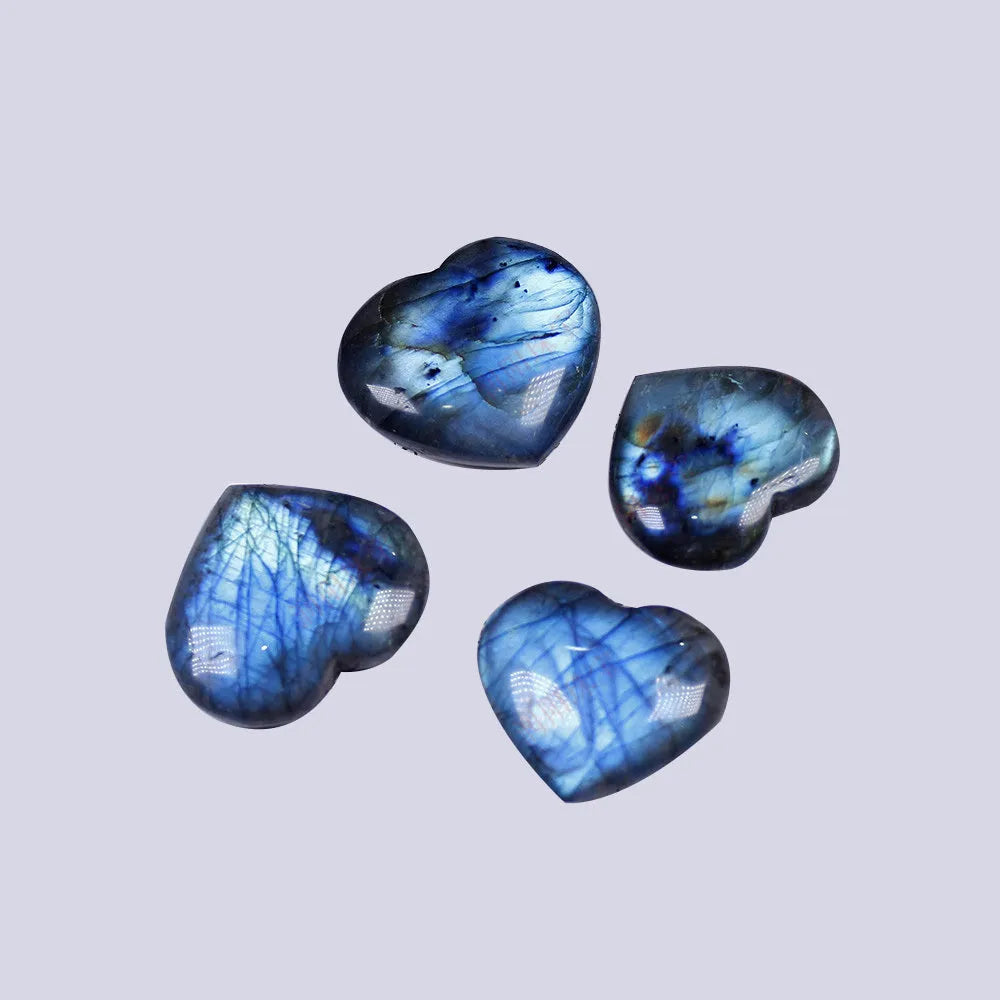 Natural blue feldspar heart-shaped handle play piece pendant on a white background.