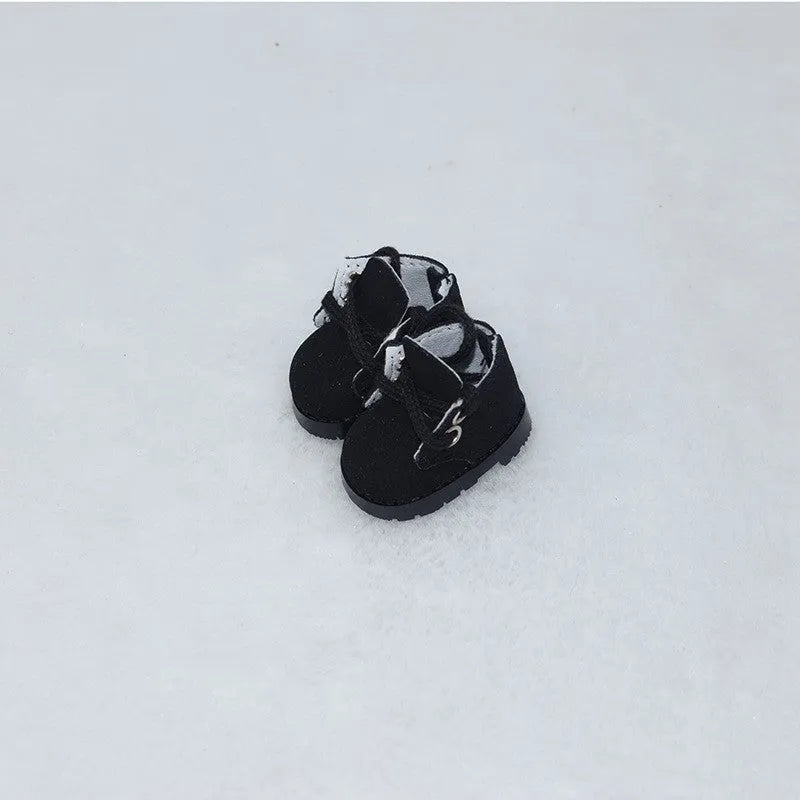 A pair of 17cm high PU replacement shoes for dolls in a selected style and colour.