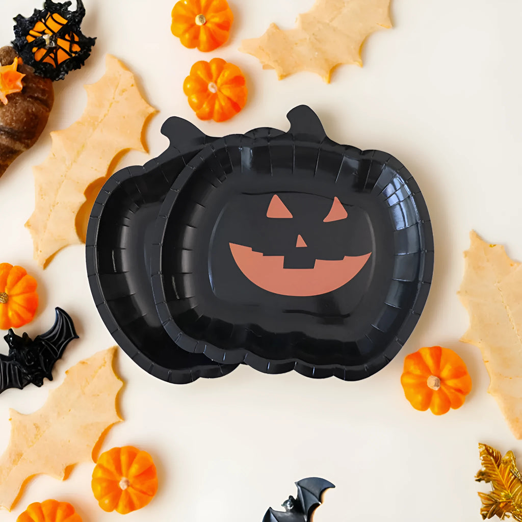 A pack of black disposable paper plates with a pumpkin design for Halloween, shown in 9-inch size.