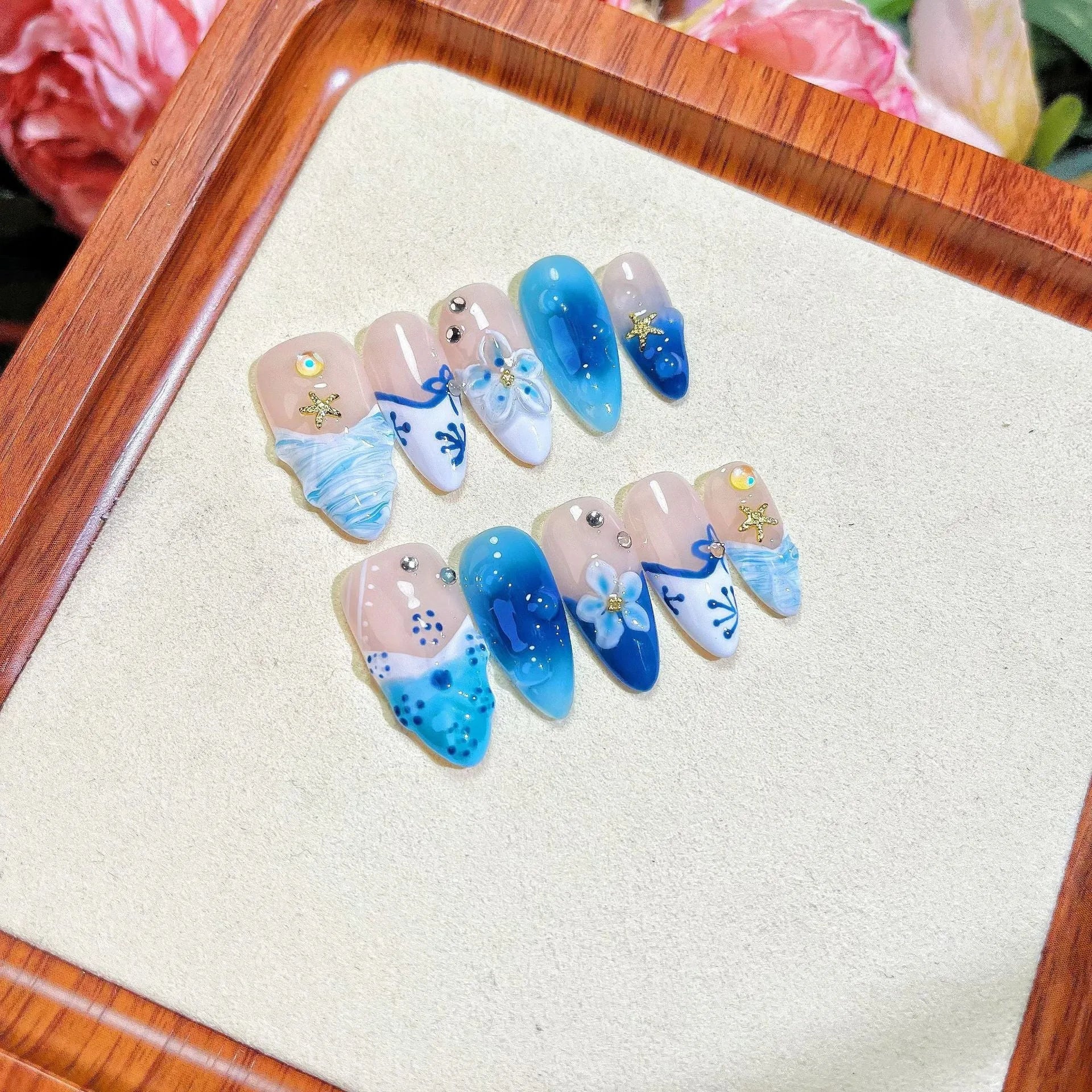 Blue transparent false nails with hand-painted carved summer ice design