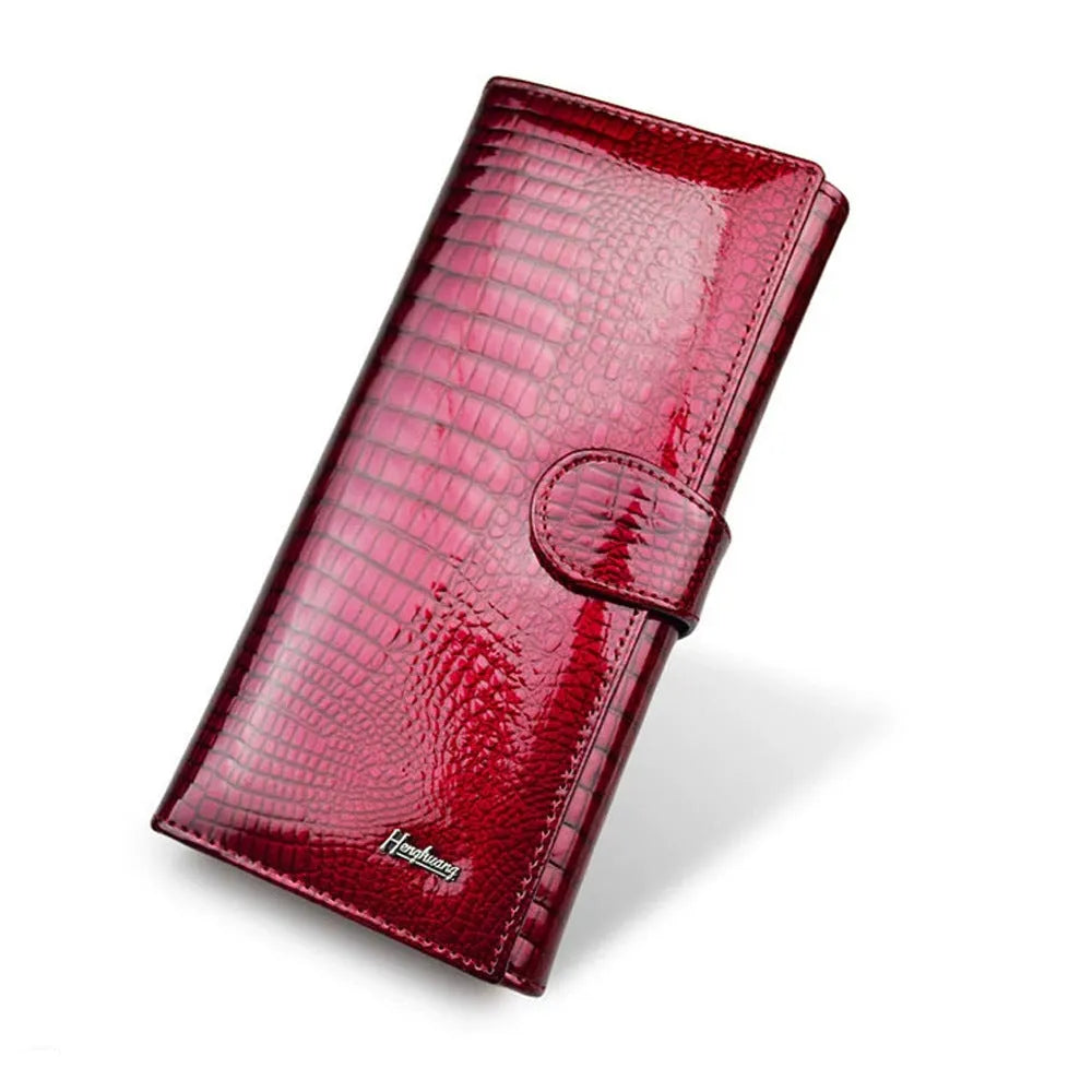 Women's leather coin purse with crocodile pattern embossing in red colour showing interior pigskin lining